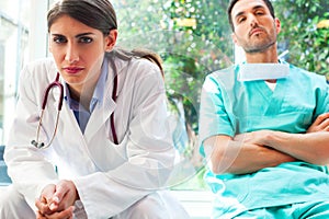 Serious female doctor with colleague in hospital