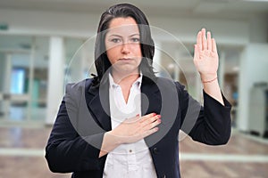 Serious female entrepreneur making honest oath gesture