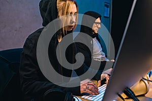 serious female hacker working on new malware with accomplice