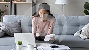 Serious female manage family finances using laptop