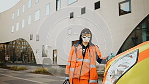 Serious female paramedic looks at you. Writing on clothes means Urgent care