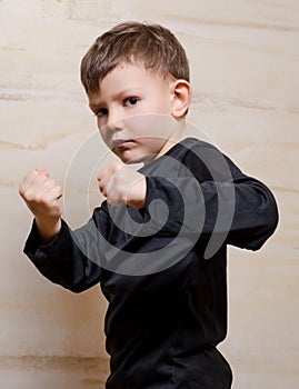 Serious Fighter Kid Posing with Closed Fists