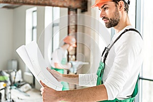 Serious foreman keeping necessary plan