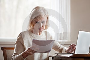 Serious frustrated middle aged woman troubled with domestic bill