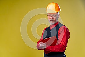 Serious general contractor or real estate investor concept with elegant man with beard, glasses and building helmet