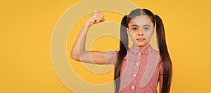 Serious girl child show power gesture flexing arm yellow background, strong. Child face, horizontal poster, teenager