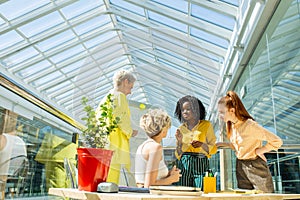 Serious girls in bright colorful casual wear discussing a topic