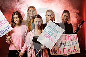 Serious girls feminists with poster call for feminists movement