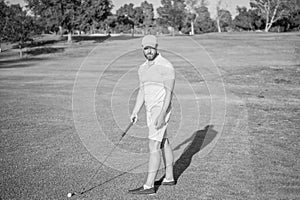 serious golfer in cap with golf club, golf player