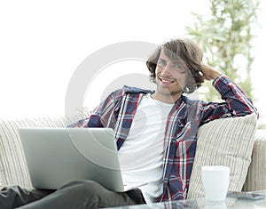 Serious guy working sitting near the desktop.