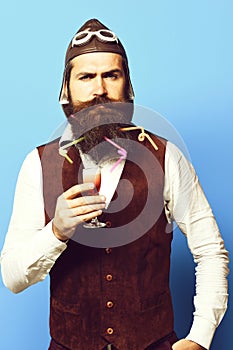 Serious handsome bearded pilot on blue studio background