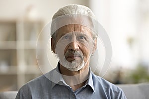 Serious handsome grey haired senior Caucasian man with hoary beard