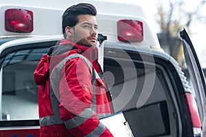 serious handsome male paramedic standing