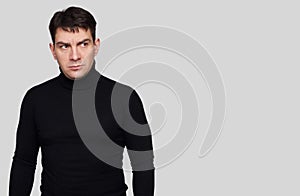 Serious handsome man wearing black turtleneck