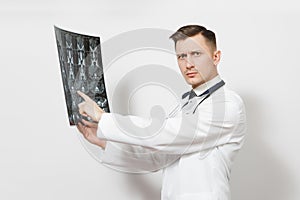 Serious handsome young doctor man holds x-ray radiographic image ct scan mri isolated on white background. Male doctor