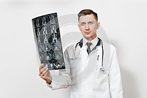 Serious handsome young doctor man holds x-ray radiographic image ct scan mri isolated on white background. Male doctor