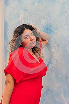 Serious happy young plus size girl in outdoor dress. xl woman on the street