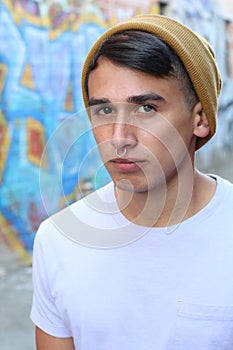 Serious hip Latino teen outdoors close up photo