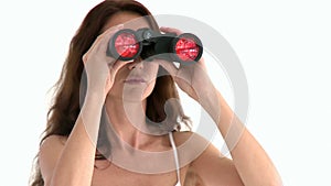 Serious hispanic woman looking through binoculars