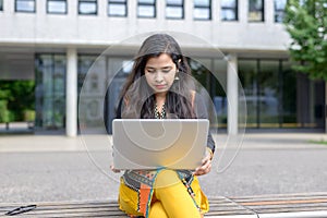 Serious Indian girl with laptop