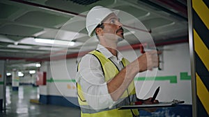 Serious inspector writing paper working underground closeup. Expert man checking