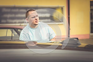 Serious intense young man in a parking lot