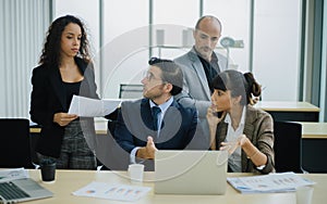 Serious international diverse business team people discuss financial result review with laptop photo