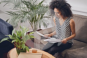 Serious lady scrutinizing documents in her office