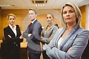 Serious lawyer standing with arms crossed