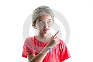 Serious little girl pointing to blank copy space