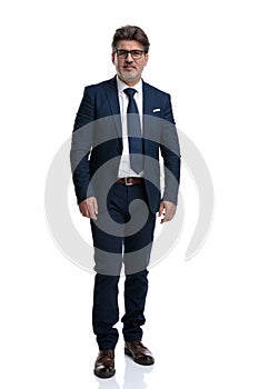 Serious looking businessman wearing an elegant blue suit