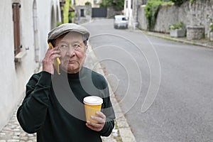 Serious looking ethnic man talking on the phone in urban setting