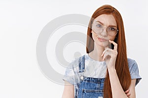 Serious-looking suspicious perplexed redhead smart girl wear glasses frowning, smirking unsatisfied and doubtful touch