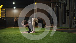 Serious male boxer warming up in sport club. Sport man exercising at gym