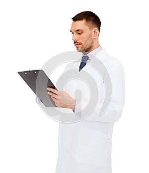 Serious male doctor with clipboard