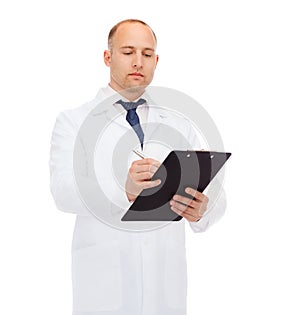 Serious male doctor with clipboard