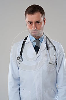 Serious male doctor with stethoscope on neck