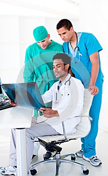 Serious male doctors looking at X-Ray