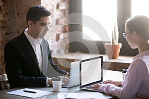 Serious male and female looking at each other struggling for leadership