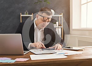 Serious man office worker is reading report