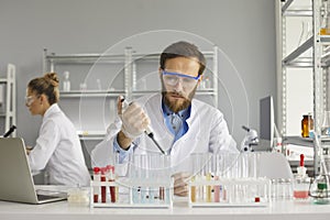 Serious male scientist working in a pharma or biotech company science laboratory