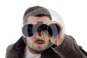 Serious male viewing through binoculars
