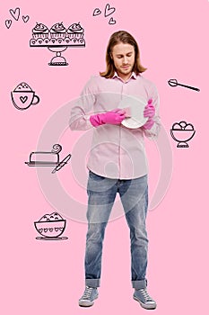 Serious man changing his gender responsibilities and washing the dishes