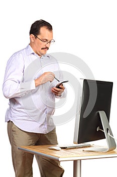 Serious man dials number standing near table with photo