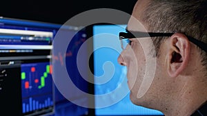 a serious man explores the securities market, looking at the financial chart. Stock market. Online investments. Buying