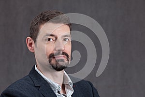 Serious Man in Forties with a goatee beard and mustache