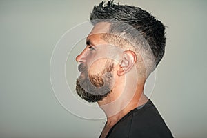 Serious man. Hipster with bearded face profile and stylish hair