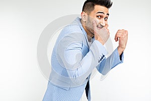 Serious man in a jacket joked and laughs on a white studio background