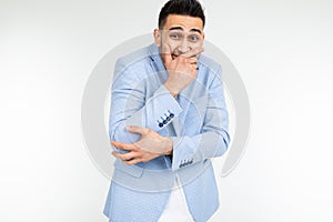 Serious man in a jacket joked and laughs on a white studio background
