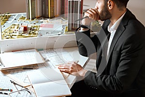 Serious man looking at the window, thoughtful , pensive designer looking for inspiration